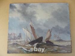 Old oil painting on canvas of a seascape with boats on a stormy coast, 19th century.