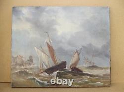 Old oil painting on canvas of a seascape with boats on a stormy coast, 19th century.