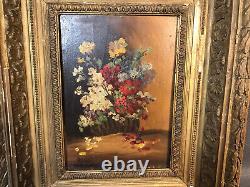 Old oil painting on wood, flower bouquet in wooden and plaster frame