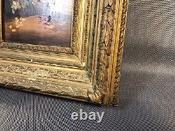Old oil painting on wood, flower bouquet in wooden and plaster frame