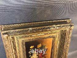 Old oil painting on wood, flower bouquet in wooden and plaster frame
