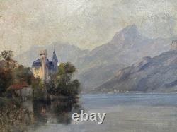 Château romantique au bord d'un lac alpin huile sur toile paysage ancien